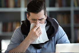 man blowing his nose