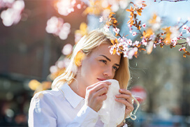 woman blowing her nose